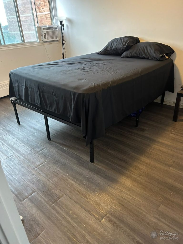 Bedroom with freshly made bed after cleaning